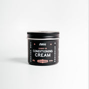Jar of leave-in conditioning cream on a white background