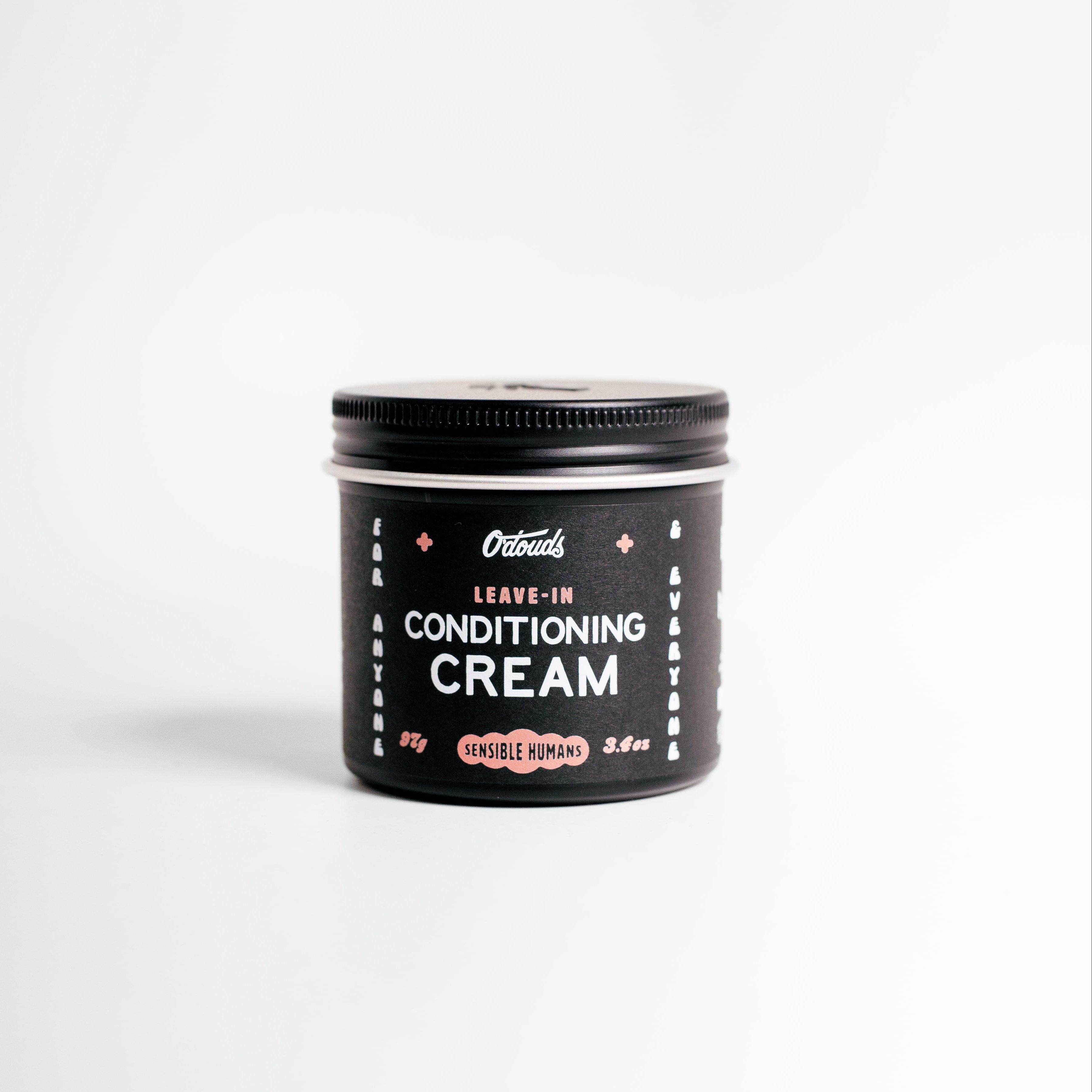 Jar of leave-in conditioning cream on a white background