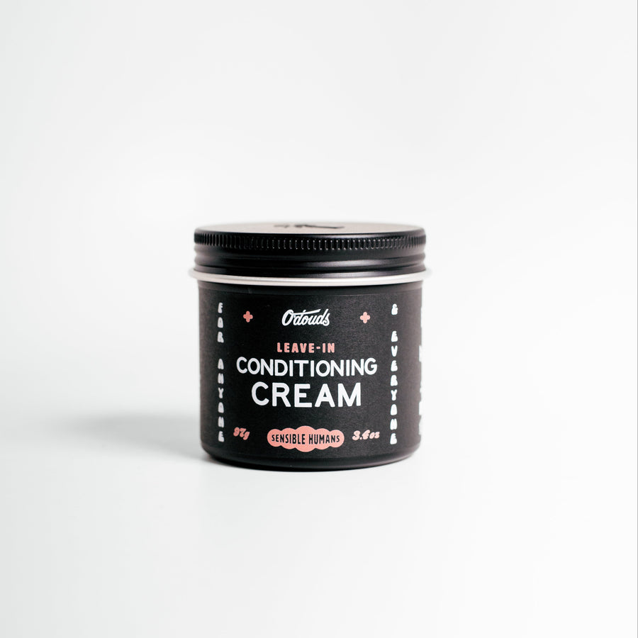 Jar of leave-in conditioning cream on a white background