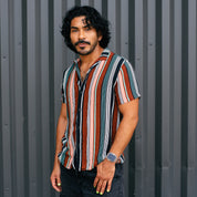 CONDITIONING_CREAM styled on person wearing a striped shirt against a metal background