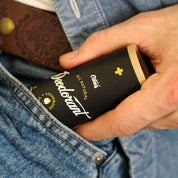 Hand pulling out Cedarwood and Orange All Natural Deodorant from blue jean pocket