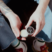 Oakmoss and Cedar Mustache Wax opened in hands