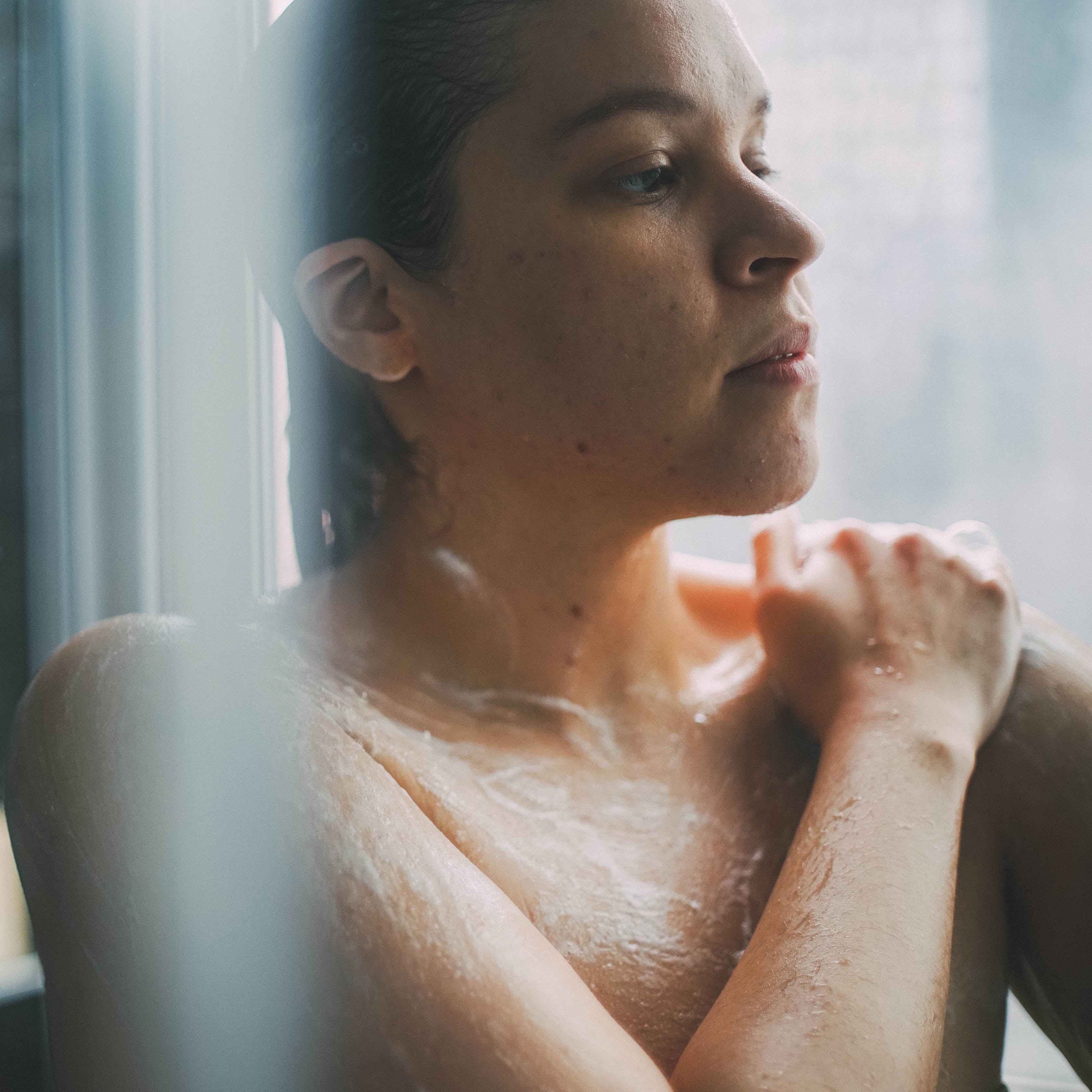 Young woman shower with Sage and Eucalyptus scented Body Wash