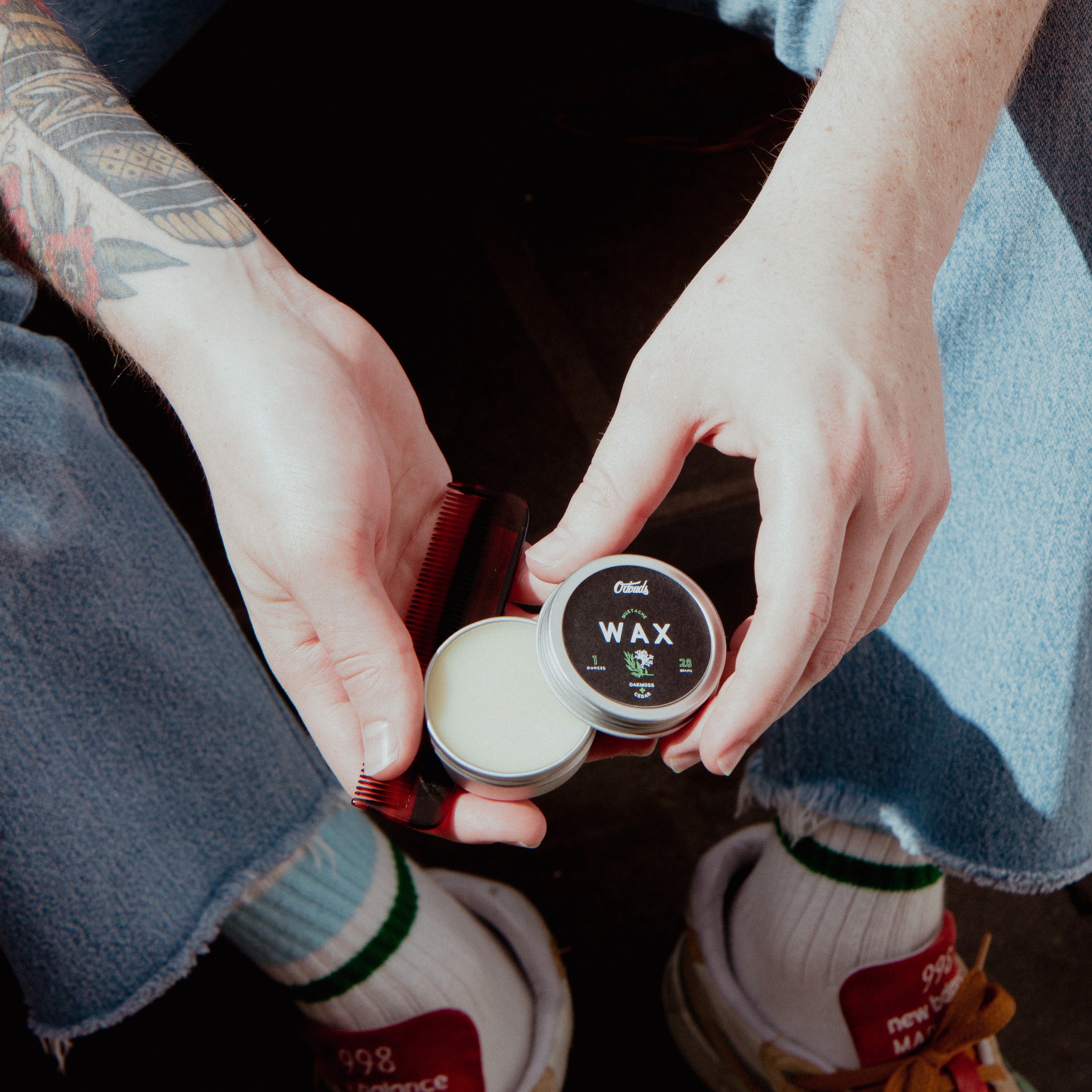 Oakmoss and Cedar Mustache Wax opened in hands 